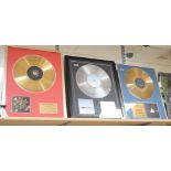 Three glazed framed award winning records: Pink Floyd, The Rolling Stones and Westlife