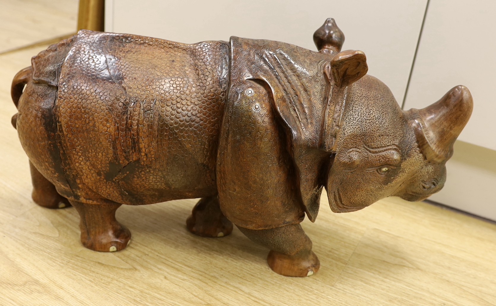 A carved wooden model of a rhinoceros, approximately 60cms long Ivory submission reference: - Image 3 of 3