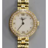 A lady's 18ct gold Longines quartz wrist watch, with mother of pearl dial and diamond chip set