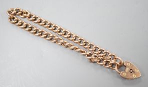 An Edwardian 9ct gold curblink bracelet, with heart shaped padlock clasp, 19cm, 11.3 grams.
