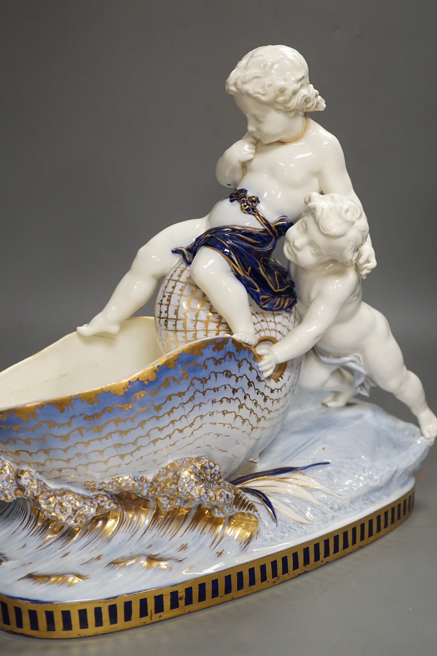 A Copeland porcelain putti seated on a shell centrepiece, modelled O. Hale, c.1877, 35cms high - Image 11 of 14