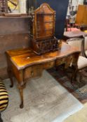 A Queen Anne Revival serpentine walnut kneehole dressing table, width 121cm, depth 54cm, height 76cm