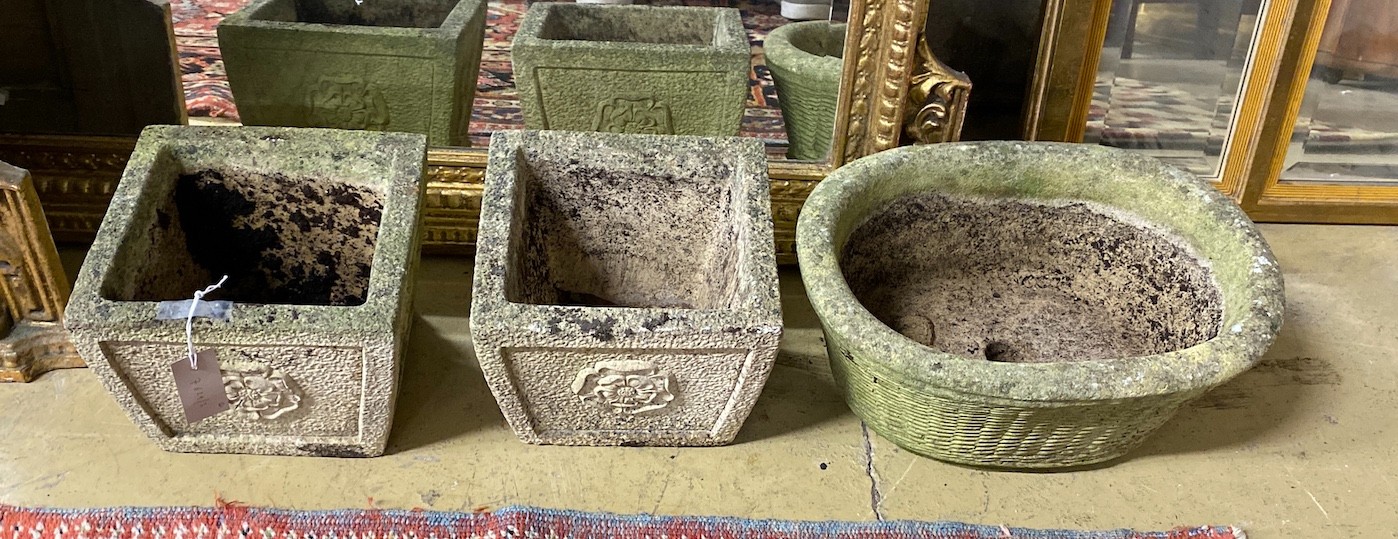 A pair of square reconstituted stone garden planters, height 19cm and a larger oval planter