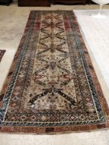 An antique Caucasian ivory ground hall carpet, 382 x 142cm