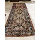 An antique Caucasian ivory ground hall carpet, 382 x 142cm