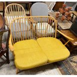 A mid century Ercol light beech three piece lounge suite, lacks three back cushions, settee length