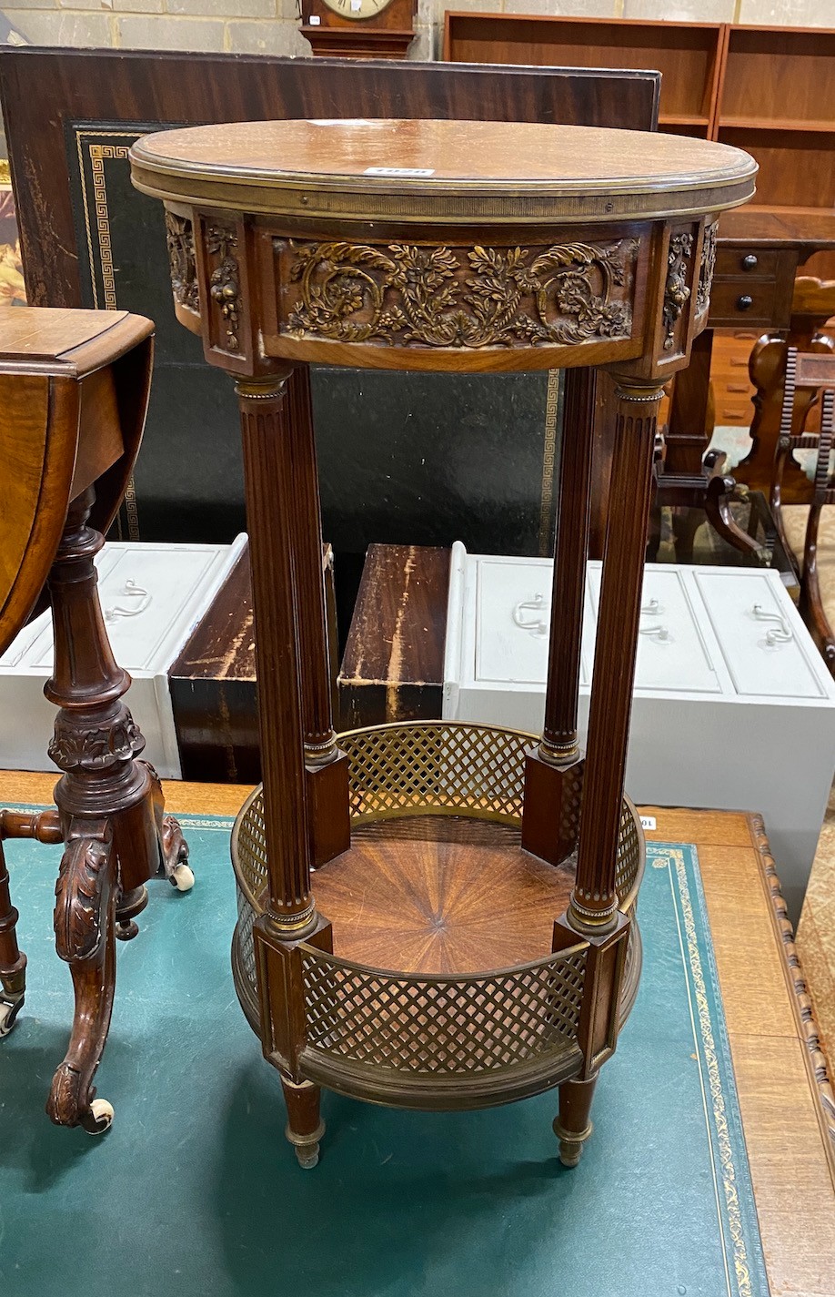 A circular French gilt metal mounted two tier table, diameter 36cm, height 74cm