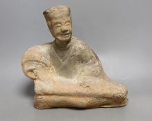A Chinese grey pottery figure of a seated musician, Han dynasty (200BCE to 220CE) or later, 25cm