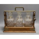 A Victorian Betjemanns patent oak cased three bottle tantalus (a.f.)