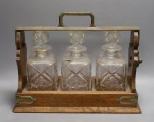 A Victorian Betjemanns patent oak cased three bottle tantalus (a.f.)