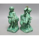 A pair of Cantagalli green monochrome putti figural bookends, 19cms high