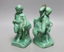 A pair of Cantagalli green monochrome putti figural bookends, 19cms high