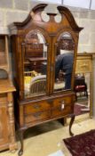 A Queen Anne revival walnut mirrored two door side cabinet, width 92cm, depth 51cm, height 206cm