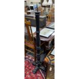 A pair of painted turned wood and wrought iron pricket candlestands, height 144cm
