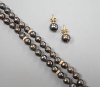A single strand Tahitian cultured pearl necklace, with yellow metal spacers and a 14k yellow metal