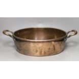 A 19th century copper two handled preserving pan, 51cms handle to handle