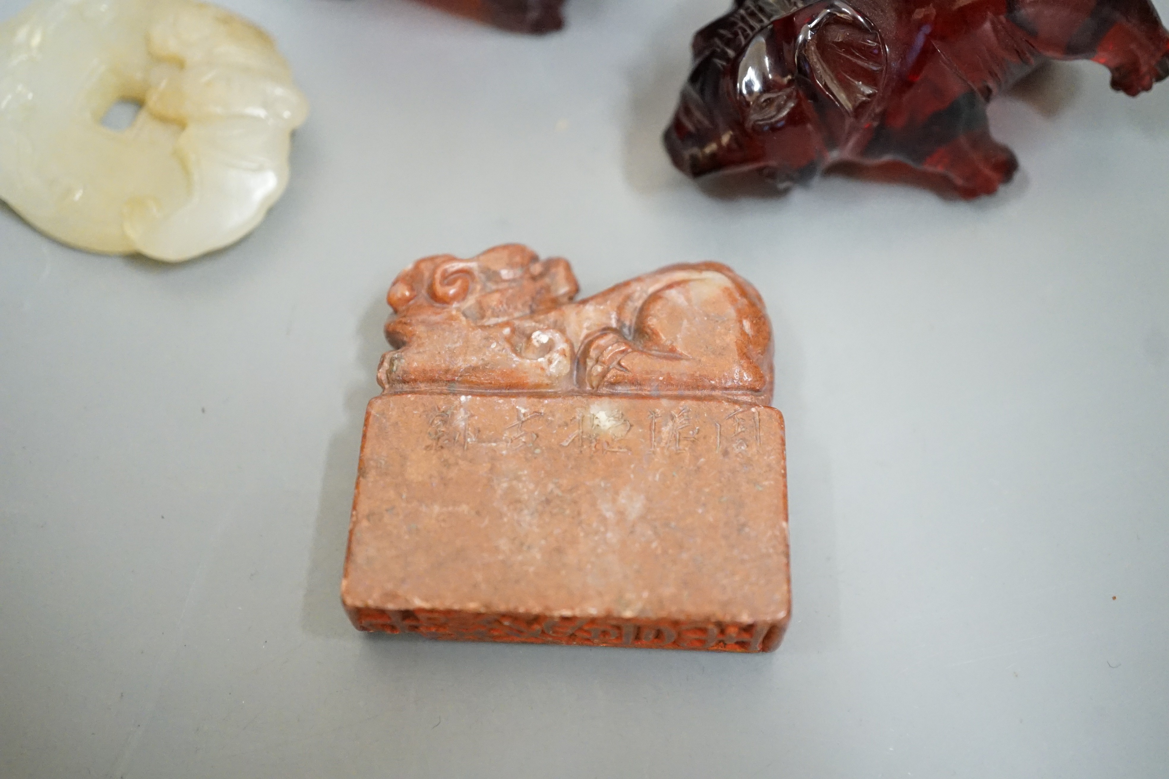 A Chinese Jade bi disc, two cherry amber ox and a soapstone seal - Image 2 of 4