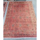 An Afghan red ground carpet, 300 x 208cm