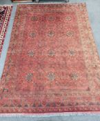 An Afghan red ground carpet, 300 x 208cm