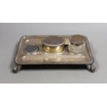 A late Victorian silver rectangular inkstand, with two wells and central lidded compartment, (