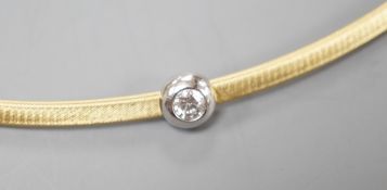 A modern 750 yellow metal and solitaire diamond set necklet, approx. 34-36cm, gross weight 8.2