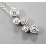 A modern Tiffany & Co platinum and graduated five stone diamond cluster set pendant necklace,