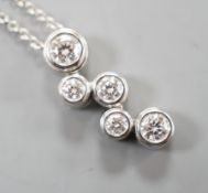 A modern Tiffany & Co platinum and graduated five stone diamond cluster set pendant necklace,