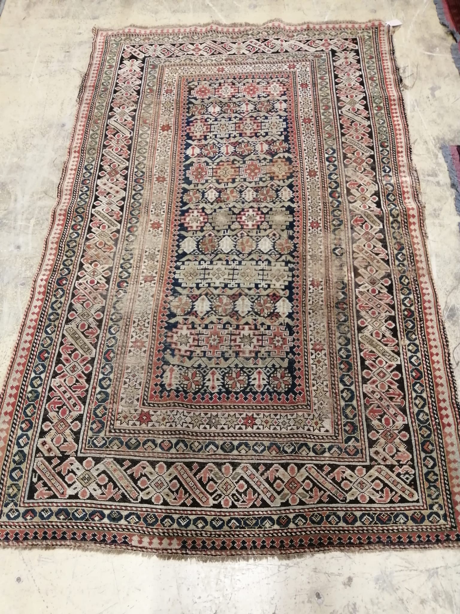An antique Caucasian blue ground rug, 190 x 115cm
