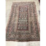 An antique Caucasian blue ground rug, 190 x 115cm