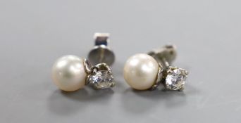 A pair of white metal cultured pearl and single stone diamond set ear studs (butterflies differ)