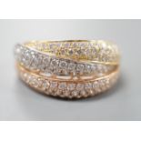 A modern three colour 18ct gold and diamond chip set triple band crossover ring, size O, gross