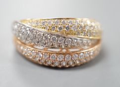 A modern three colour 18ct gold and diamond chip set triple band crossover ring, size O, gross