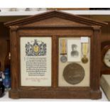 An oak framed and glazed WWI presentation group to Rifleman William Mervyn Polleck Trower, including