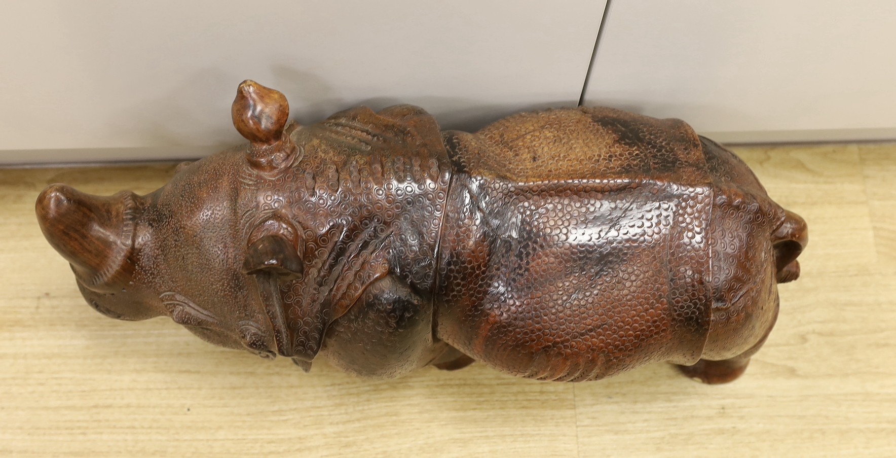 A carved wooden model of a rhinoceros, approximately 60cms long Ivory submission reference: - Image 2 of 3