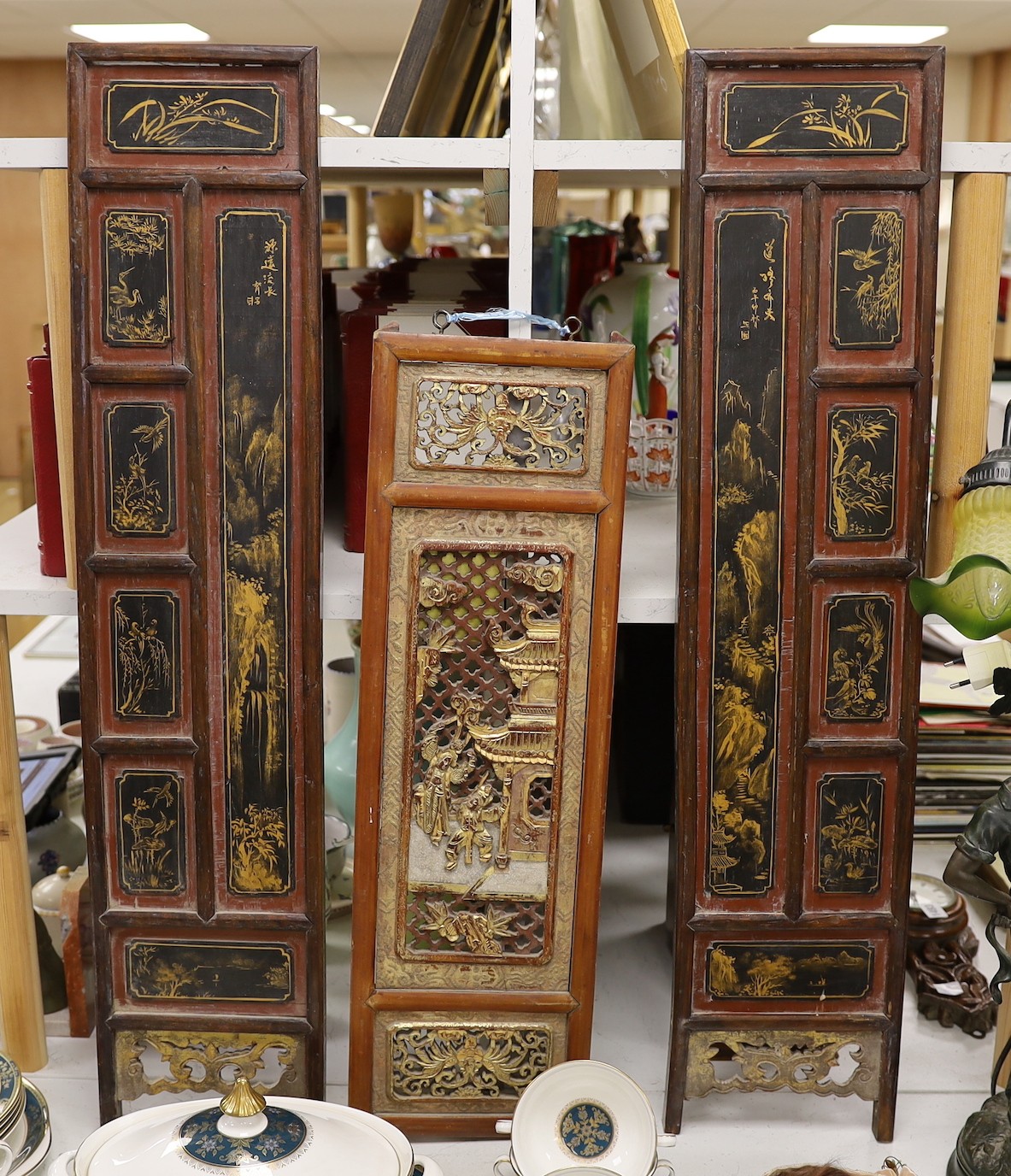 A pair of late 19th century Chinese gilt-decorated lacquer panels and a similar smaller