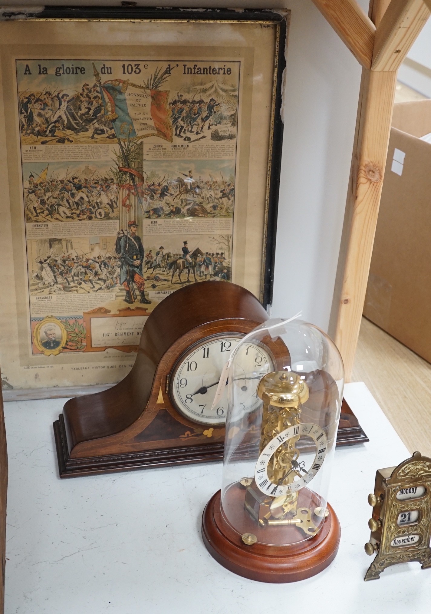 An early 20th century inlaid mahogany mantel clock, a skeleton clock under glass dome, a brass
