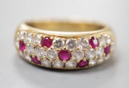 A modern yellow metal, ruby and diamond cluster set half hoop ring, size L/M, gross weight 4.5