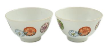 A pair of Chinese enamelled porcelain tea bowls, Qianlong seal marks, 7cms diameter