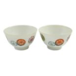 A pair of Chinese enamelled porcelain tea bowls, Qianlong seal marks, 7cms diameter