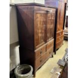 A George III mahogany linen press converted to a hanging wardrobe with part dummy drawer front,