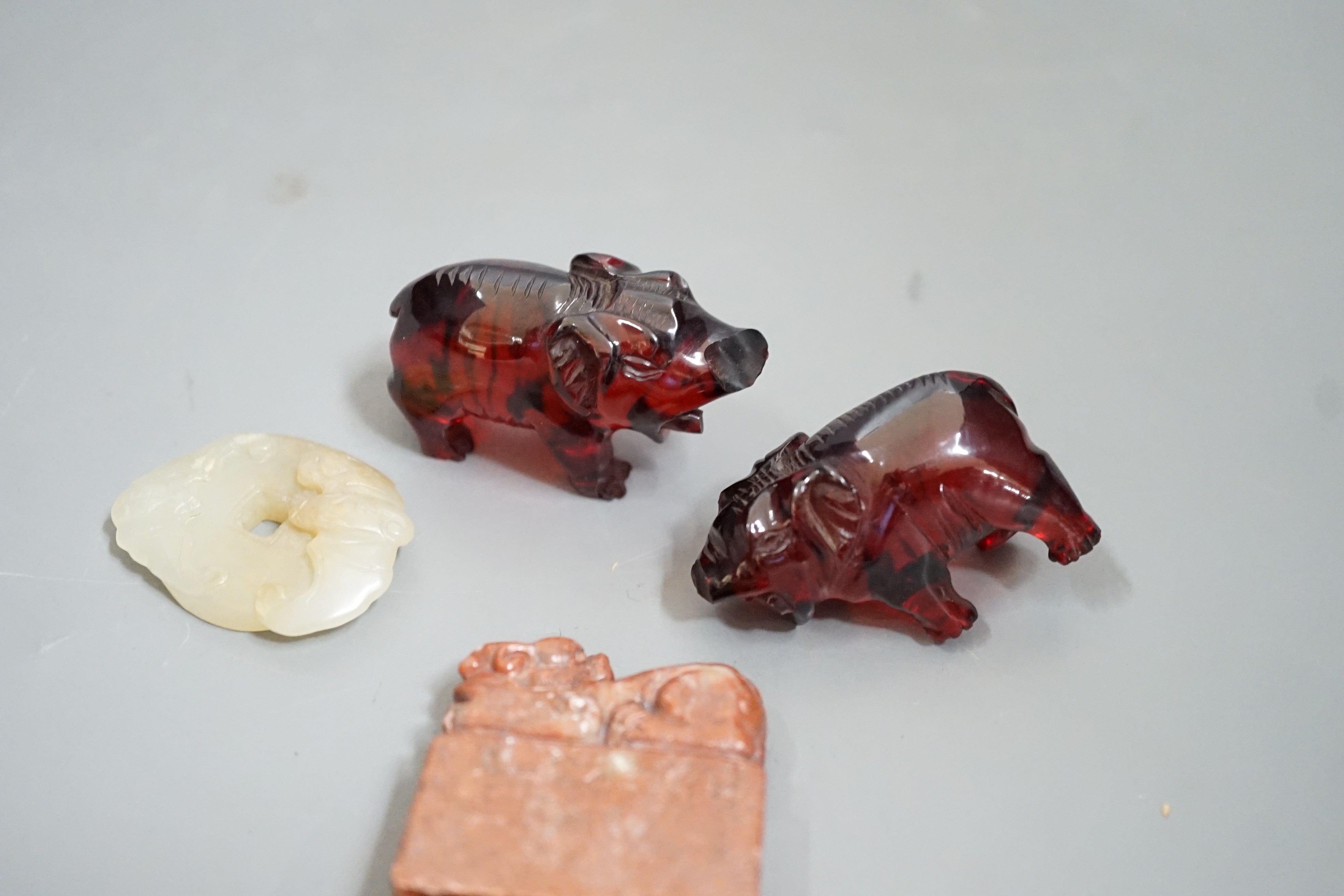 A Chinese Jade bi disc, two cherry amber ox and a soapstone seal - Image 4 of 4