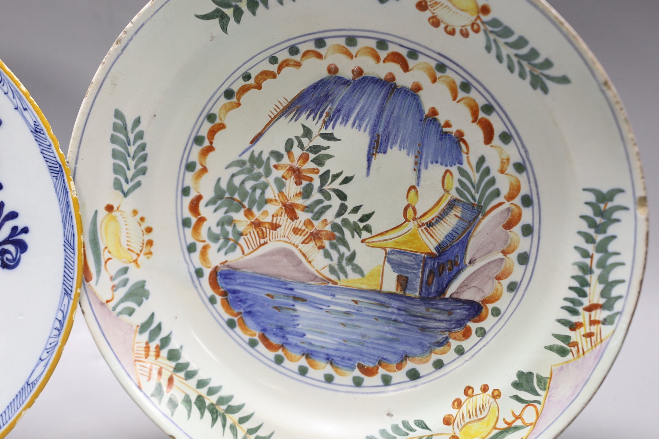 An early 18th century Delft polychrome dish and a mid 18th century Delft blue and white plate, - Image 3 of 4