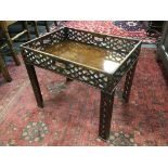 A George III pierced mahogany rectangular tray now as an occasional table on associated legs,