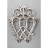 A white metal entwined twin heart brooch, with scrolling terminal, unmarked, 70mm.