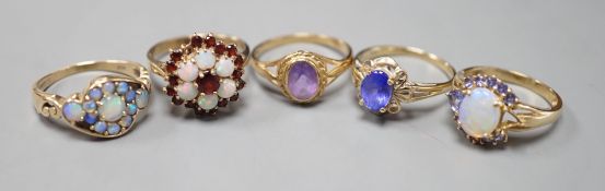 Five assorted modern 9ct gold and gem set dress rings, including, white opal cluster, garnet and