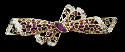 A mid to late 20th century pierced 18ct gold, ruby and diamond set ribbon bow brooch, with central