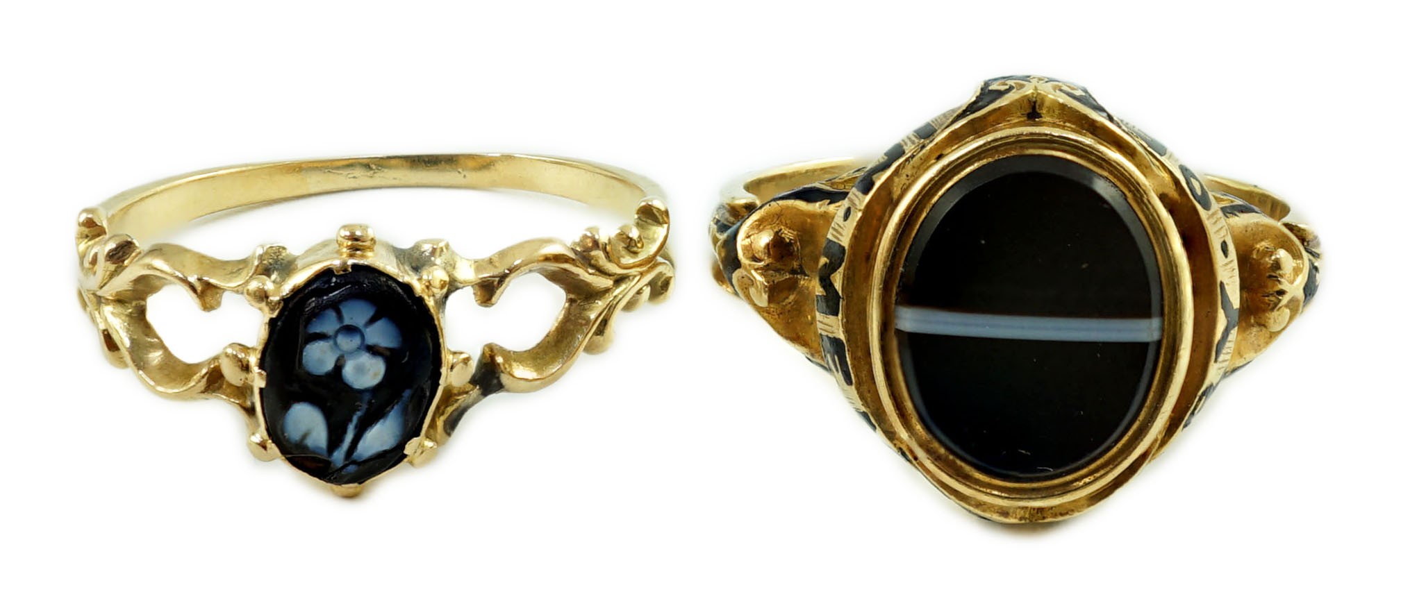 Two Victorian gold and chalcedony set mourning rings, one with oval banded agate, enamelled 'In