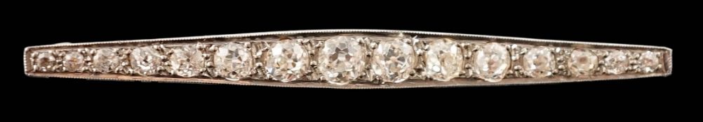 A 1920's gold, platinum and millegrain set graduated old round cut diamond bar brooch, of tapering