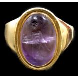 A Roman oval intaglio amethyst, carved with a figure with staff and pedestal, set in a later heavy