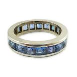 A platinum? and square cut sapphire set full eternity ring, size O, gross weight 7.7 grams.***